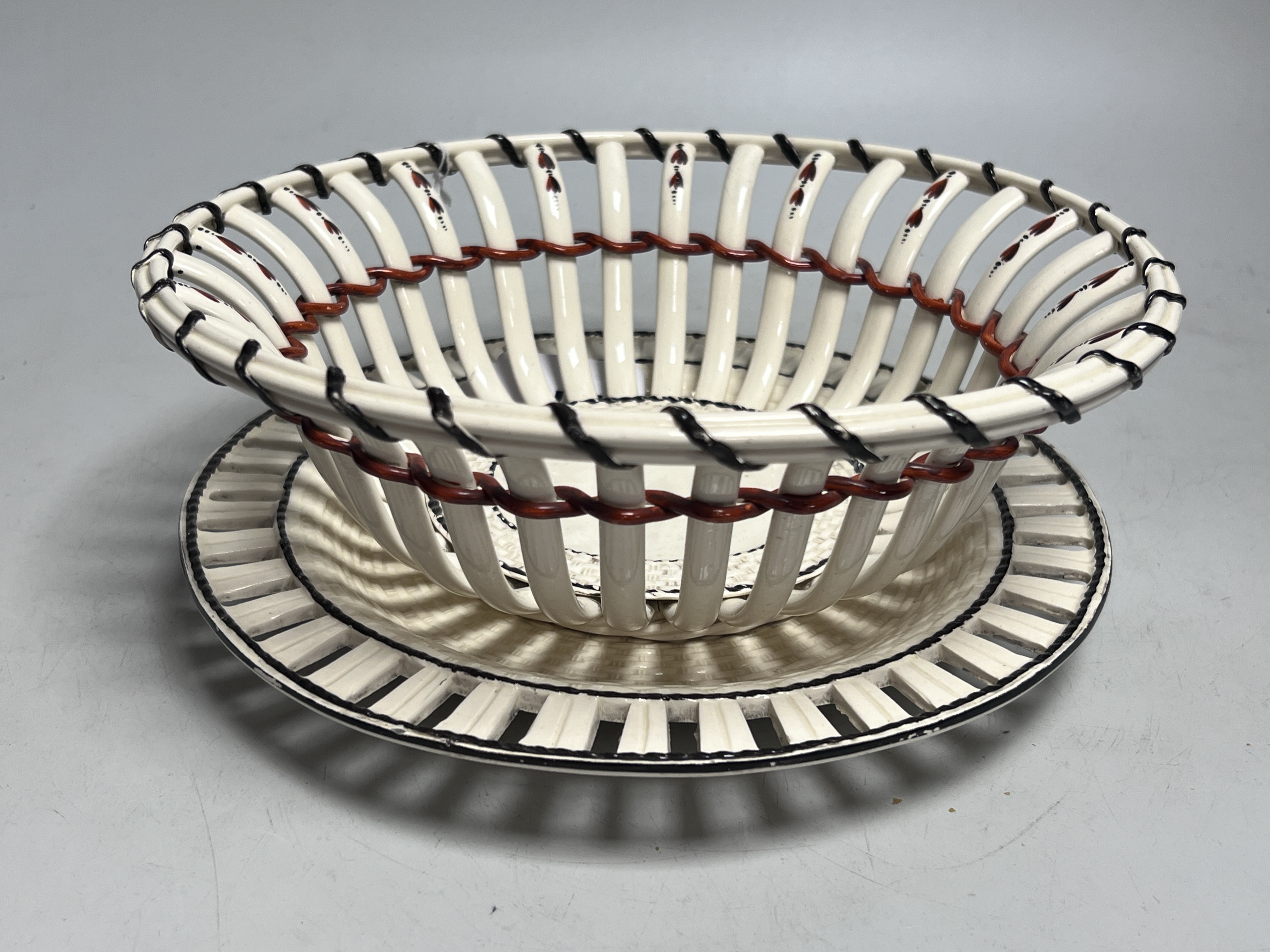 An early 19th century creamware chestnut basket and stand, 24cm